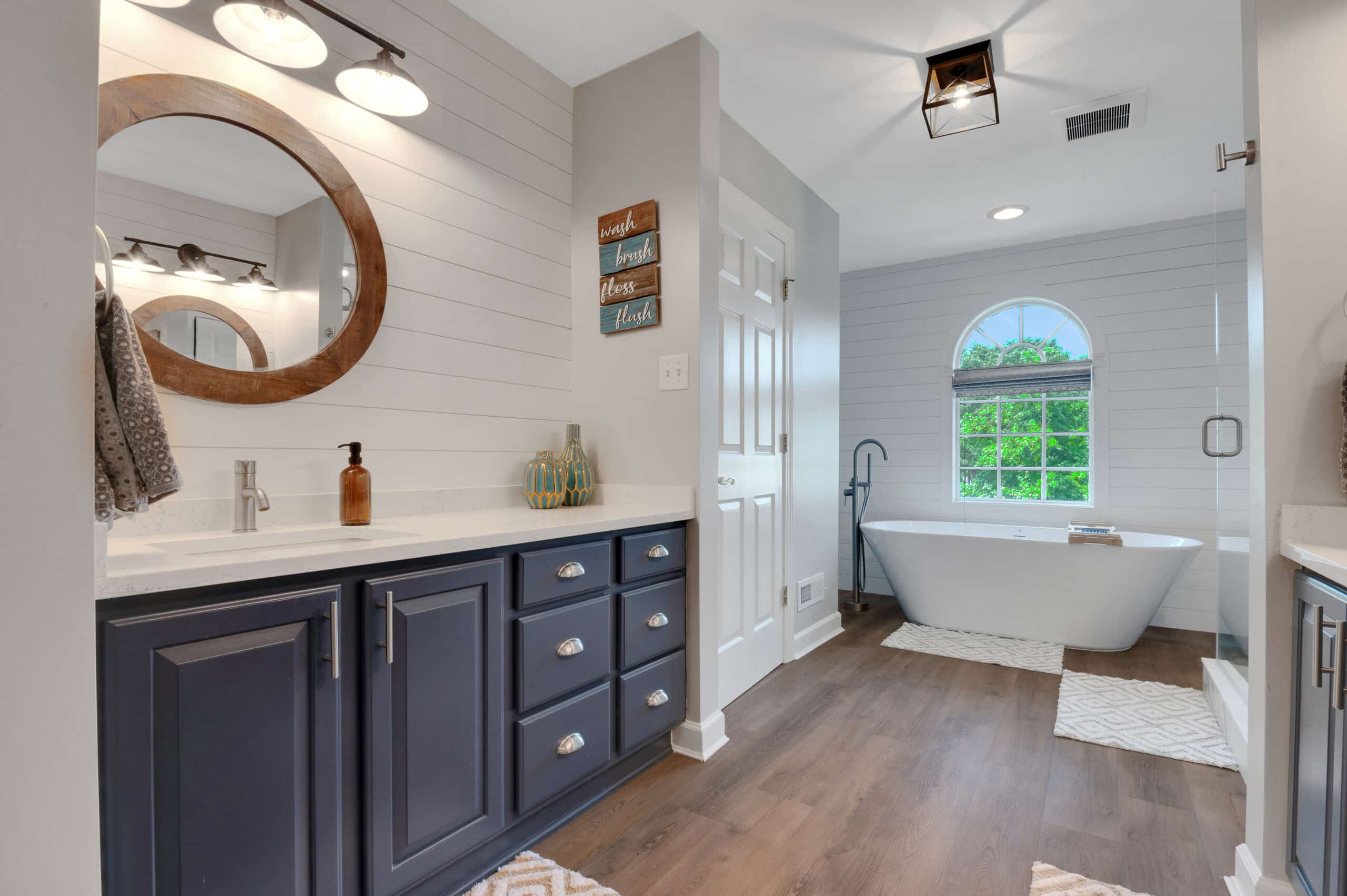 Professional real estate listing photograph of a bathroom with tile shower
