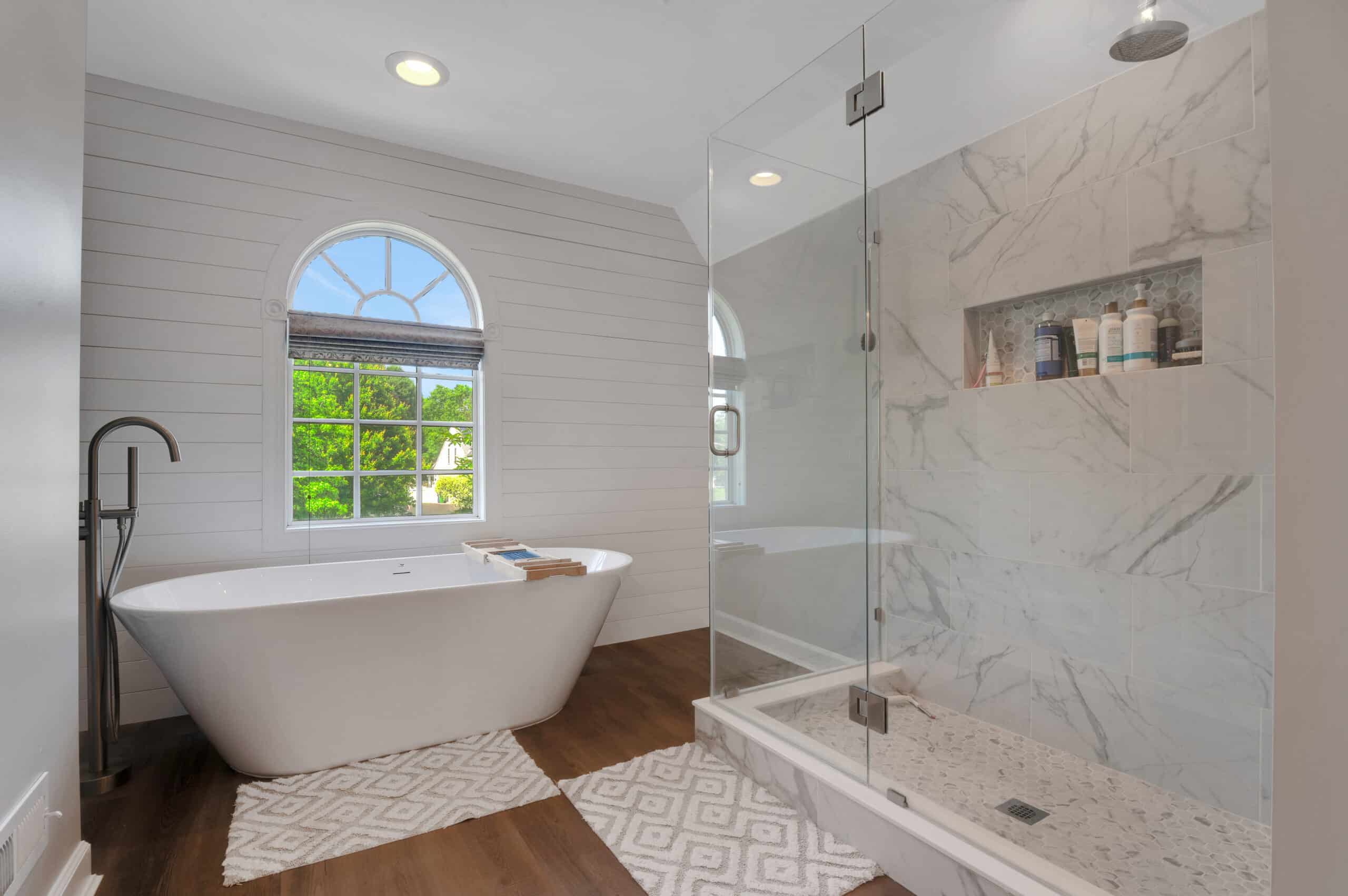 Professional real estate listing photograph of a renovated primary bathroom