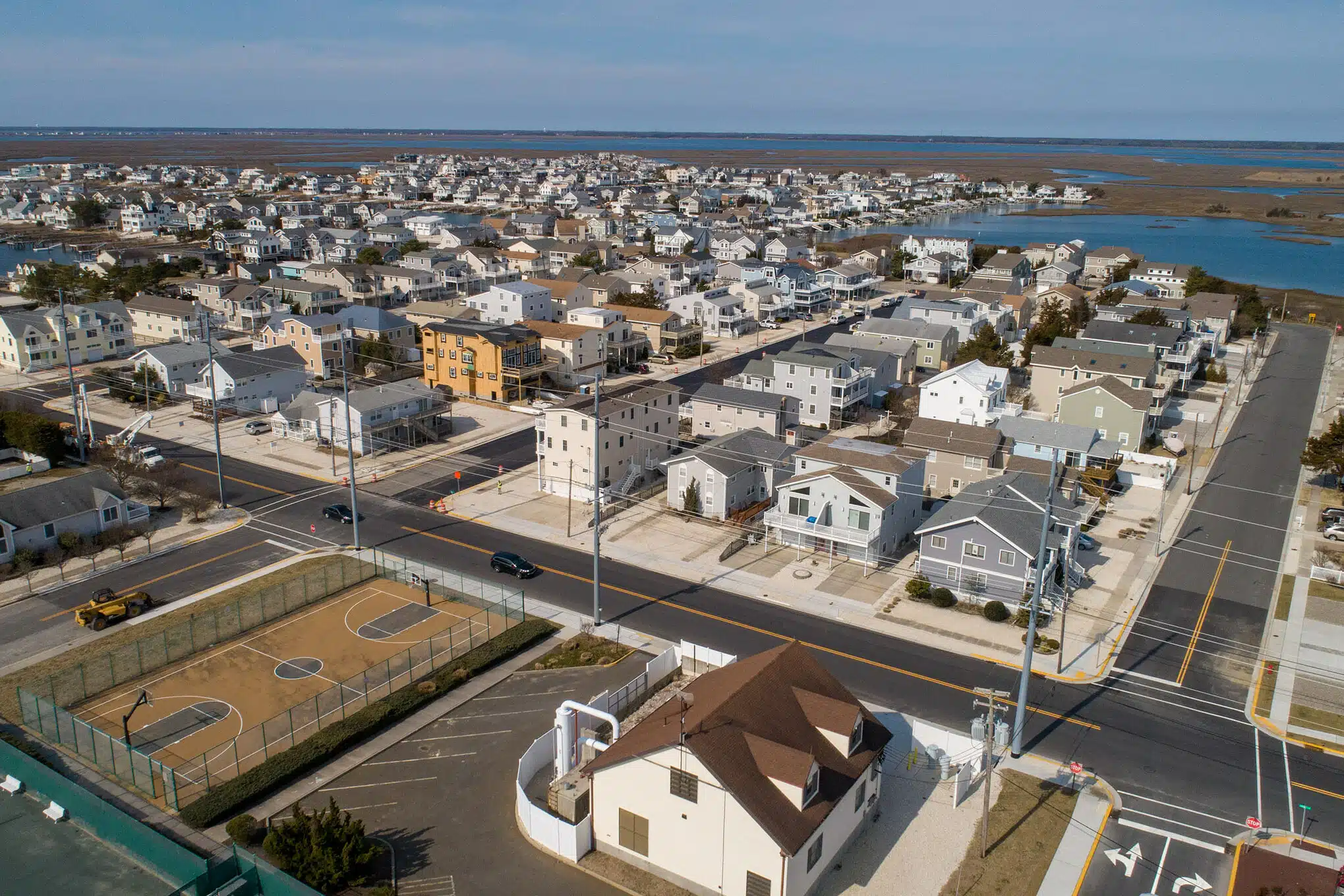 Aerial view of Avalon, NJ homes with the bay and marsh behind them