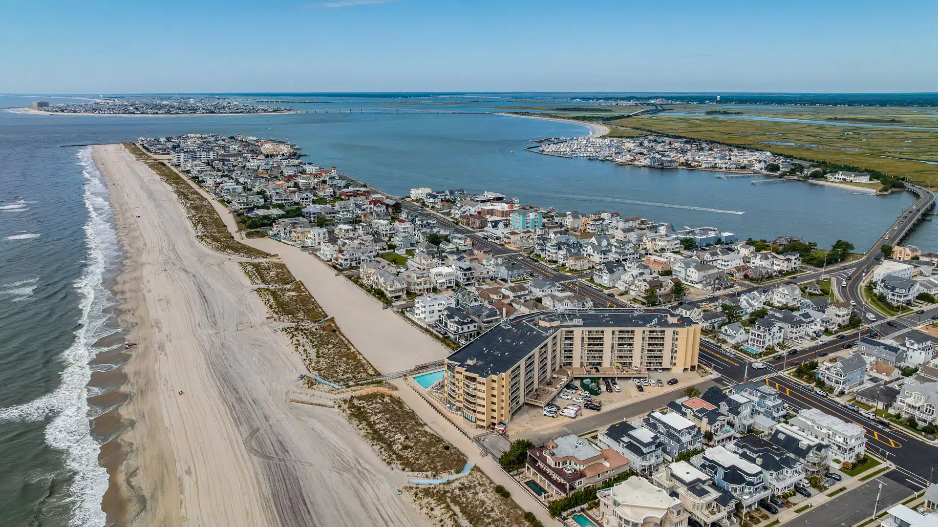 Aerial view looking down the Longport, NJ beach toward the southern tip, with Ocean Plaza in front